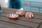 1:12 scale miniature metal bundt and jelly mold pans in shiny copper, set of 3, shown on a wood table