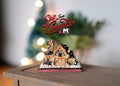 1:12 scale miniature Christmas gingerbread house with white iced roof and candy decorations, shown on a wood table