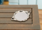 1:12 scale miniature metal ornate serving tray with handles and cake plate in silver, set of 2, shown on a wood table