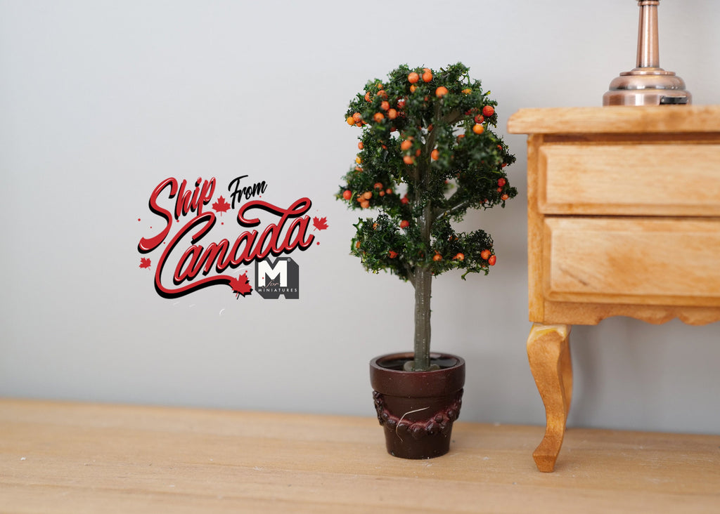 1:12 scale miniature potted topiary tree with flowers, ball shape on a slim trunk in a dark pot, beside a wood nightstand