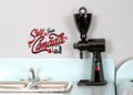 1:10 scale miniature electric coffee bean grinder in black with hopper on top, shown beside a kitchen sink