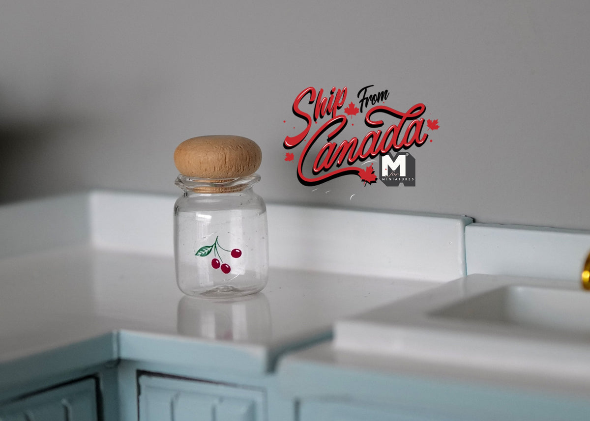 1:12 scale miniature glass jar with small red fruit design and cork lid, shown on a mint kitchen counter