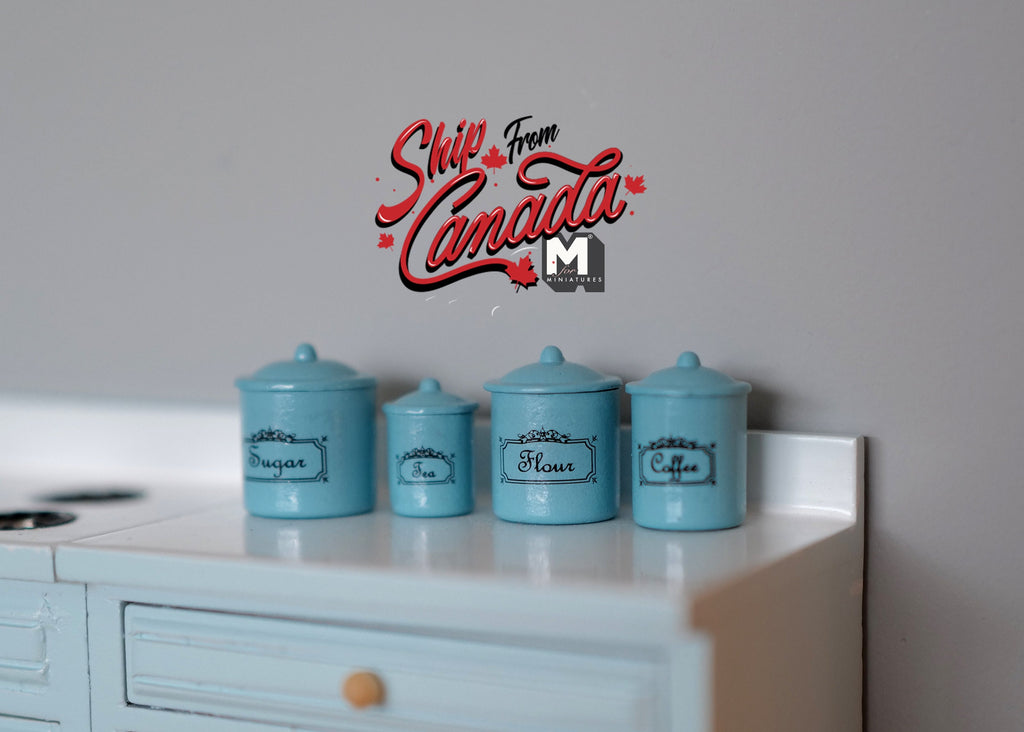 1:12 scale miniature kitchen canisters with lids in blue, set of 4 with printed labels, on a white kitchen counter