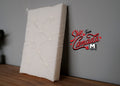 1:12 scale miniature quilted double mattress in cream with stitched pattern, shown leaning against a gray wall