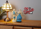 1:12 scale miniature colonial couple figurines in blue and white, set of 2, shown on a wood dresser beside a lamp