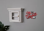 1:12 scale miniature wood medicine cabinet in white with door, shelves and crown top, shown mounted on a gray wall