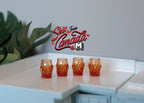 1:12 scale miniature drinking glasses in amber, set of 4, textured tumblers shown in a row on a white counter
