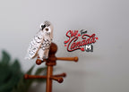 1:12 scale miniature snowy owl in white with black markings, shown perched on a wood coat stand