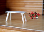 1:12 scale miniature wood rectangular coffee table in white with splayed legs, shown on a wood floor