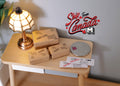 1:12 scale miniature parcel boxes and envelopes, set of 5, kraft brown boxes and white mail, on a desk beside a lamp