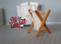 1:12 scale miniature foldable laundry basket with crossed wood frame and white fabric bag, on a gray tiled floor