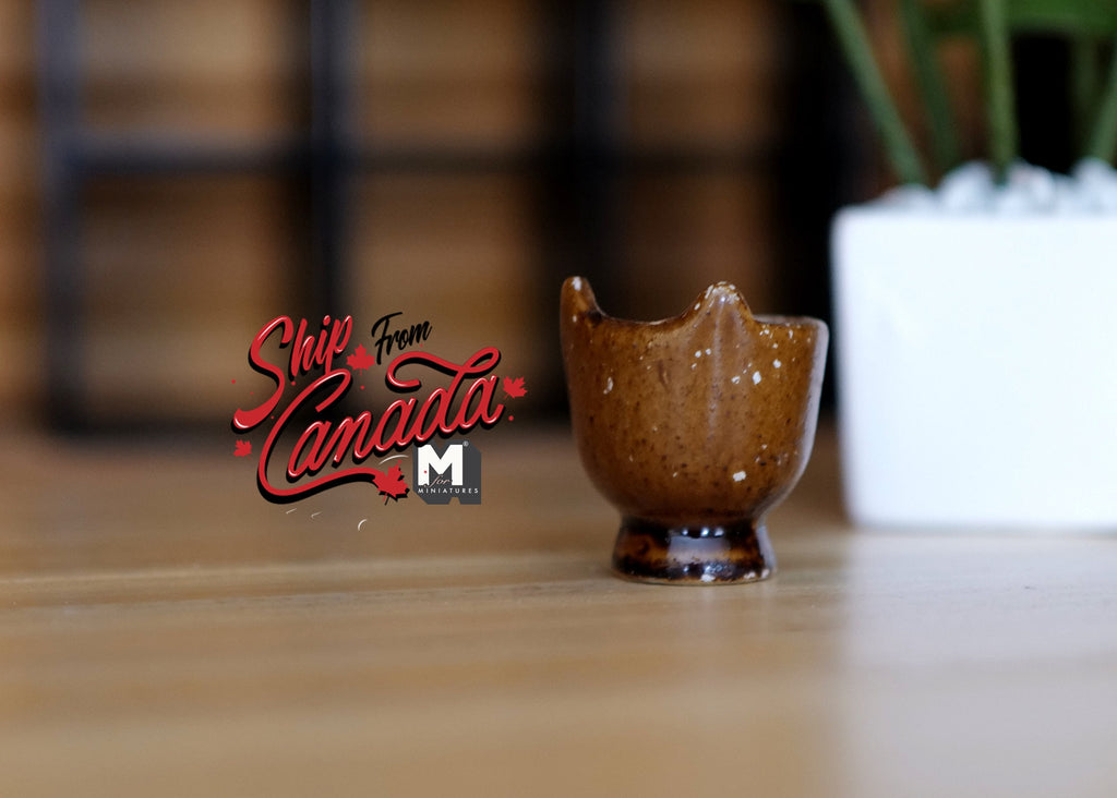 1:12 scale miniature brown glazed ceramic footed urn planter with scalloped rim, shown on a wood table
