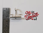 1:12 scale miniature double handle faucet in silver with curved spout, shown beside a metal ruler for scale