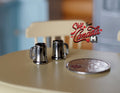1:12 scale miniature metal beer mugs in pewter with handles, set of 2, shown on a round table beside a coin