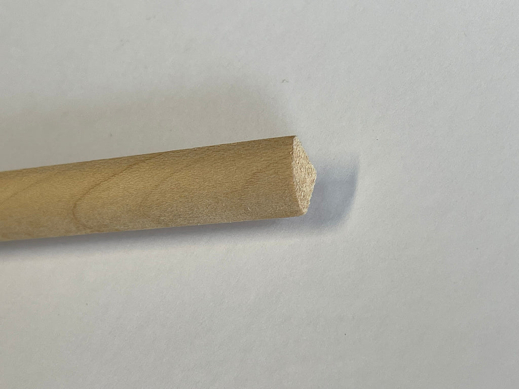 Miniature quarter round wood cornice molding for ceilings, long unfinished strip, end profile shown close up