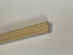 Miniature rounded edge wood trim molding for walls, unfinished natural wood, close-up of the ribbed profile end