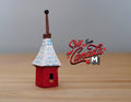 1:12 scale miniature red Irish cottage birdhouse with white and blue thatched style roof and tall finial