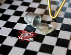 1:12 scale miniature metal bucket with spilled water, tipped over, silver, shown on a black and white checkered floor