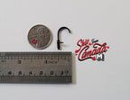 1:12 scale miniature black single handle faucet with curved spout, shown beside a coin and a ruler