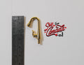 1:12 scale miniature single handle faucet in gold with curved spout, shown beside a metal ruler for scale