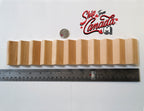 1:12 scale miniature unfinished wood staircase with 11 treads, shown lying flat with a ruler and coin for scale
