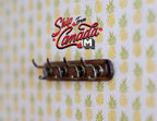1:12 scale miniature classic style coat rack with wall hooks, dark wood rail, shown on pineapple print wallpaper