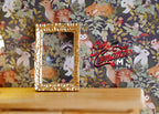 1:12 scale miniature ornate rectangular picture frame in gold, empty, shown against woodland animal wallpaper