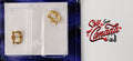 1:12 scale miniature gold bail drawer pulls with rosettes, set of 2, shown in clear packaging on a dark card
