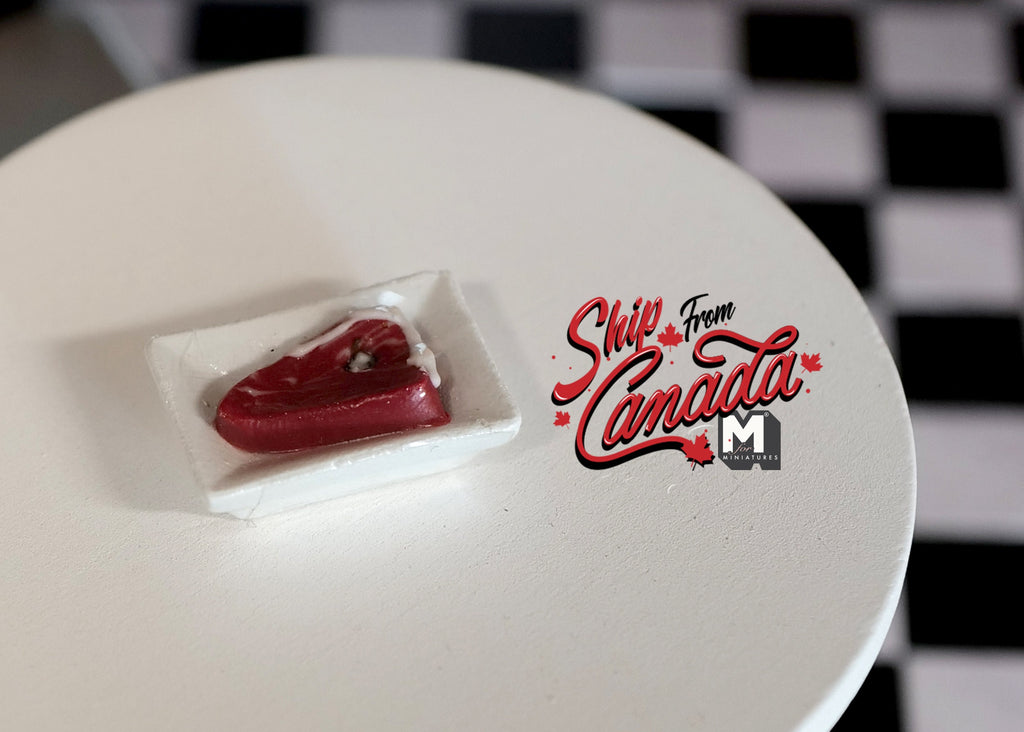1:12 scale miniature raw steak on a white rectangular tray, non edible, shown on a round white table