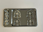 1:12 scale miniature cooktop kit in silver with 4 burner grates and control knobs, unassembled, on a white surface