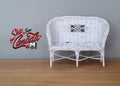1:12 scale miniature white metal wicker style garden loveseat with a woven curved back, shown on a wood floor