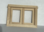 1:12 scale miniature unpainted 2 sash casement window in natural wood, shown leaning on a white wall
