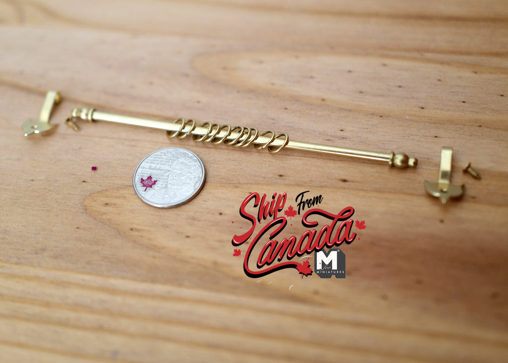 1:12 scale miniature expanding brass metal curtain rod with 2 hangers and 10 rings, on a wood surface beside a coin