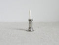1:12 scale miniature dining candle with holder, white candle in a silver candlestick, shown on a light gray surface