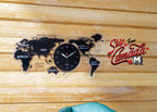 1:12 scale miniature world map wall clock in black with continent names and round clock face, shown on a wood plank wall