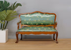 1:12 scale miniature wood loveseat with mint green damask upholstery and carved frame, shown beside a potted plant