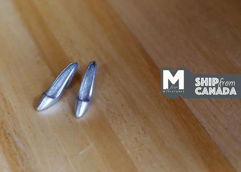 1:12 scale miniature silver high heel shoes, 1 pair, pointed toes, shown on a wood floor