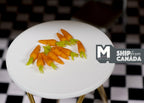 1:12 scale miniature carrots with green tops, set of 10, orange carrots piled on a round white table