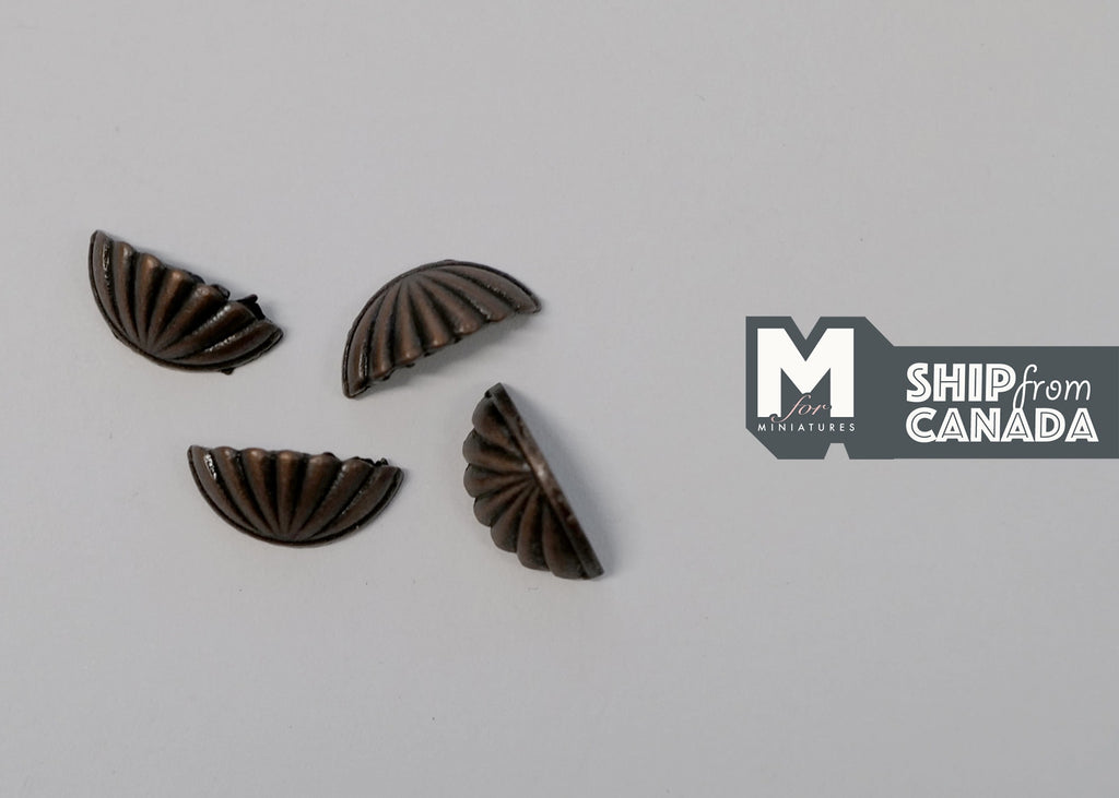 1:12 scale miniature bronze half moon cabinet pulls with fluted fan design, set of 4, on a gray surface