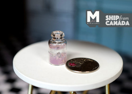 1:12 scale miniature bottle of pink juice with ice and lid, shown beside a coin on a round white table