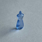 1:12 scale miniature dish soap bottle in translucent blue with a curved waist, shown on a gray surface