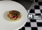 1:12 scale miniature sliced ham and shrimp arranged on a round plate, shown on a white table