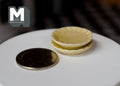 1:12 scale miniature ceramic scalloped plates in beige, set of 2, stacked on a white table beside a coin for scale