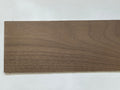 Miniature walnut wood sheet for flooring and walls, dark brown natural grain, thin plank shown on a white surface