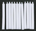 1:12 scale miniature taper candles in white with wicks, set of 12, shown laid in a row on a black background