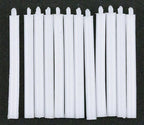 1:12 scale miniature taper candles in white with wicks, set of 12, shown laid in a row on a black background