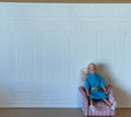 1:12 scale miniature Ionic column wall panel in white embossed foam board, shown behind a seated figure in an armchair