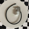 1:12 scale miniature metal paint spray gun with black hose, silver gun with paint cup, shown on a round white table