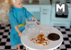 1:12 scale miniature glass cookie jar with white chocolate cookies and lid, shown on a white table beside a doll and a coin