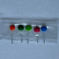1:12 scale miniature lollipops in assorted colors, set of 5, orange, green, pink and blue on clear sticks in a sleeve